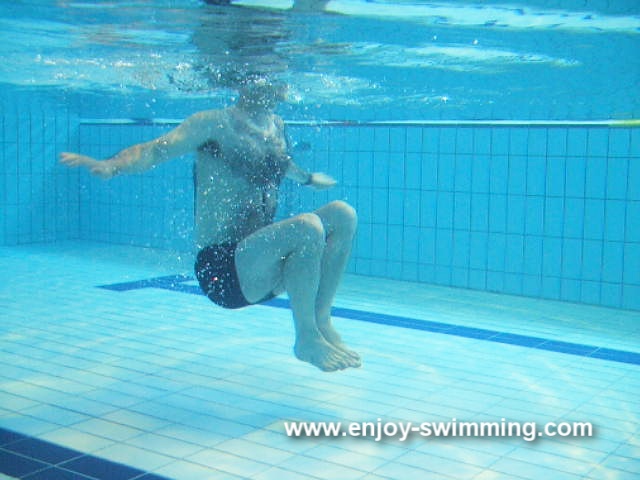 A boy sculling water to stay afloat